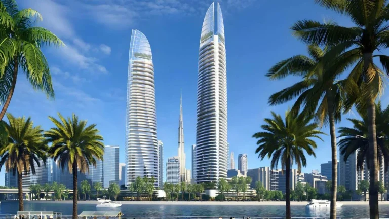 Two skyscrapers framed by palm trees, representing Dubai's